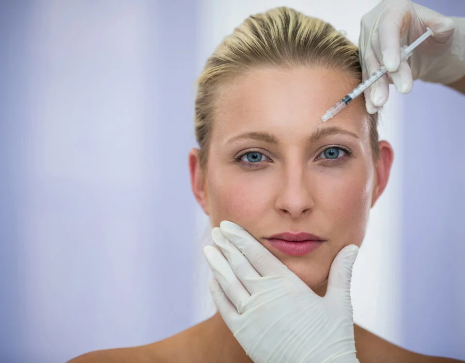 close-up of female patient receiving a botox injection on forehead